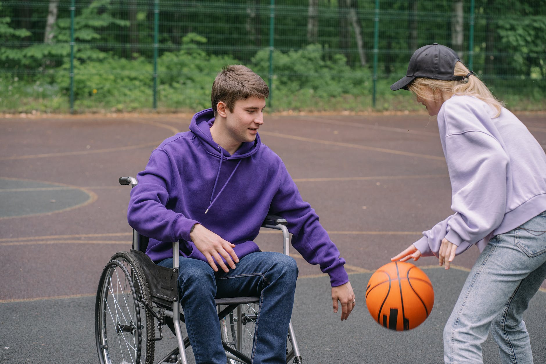 a man and woman playing basketball together