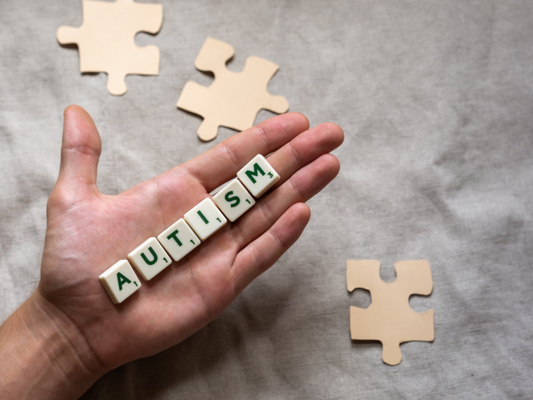 person holding scrabble letters